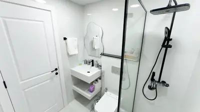a bathroom with a shower and a toilet and a sink at Dubai Marina - Cozy Studio Apartment in Dubai