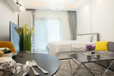 a living room with a bed and a coffee table at Dubai Marina - Cozy Studio Apartment in Dubai