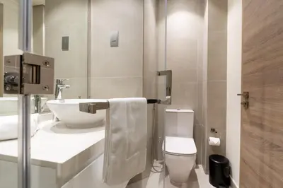 a bathroom with a toilet and a sink at Beautiful Stylish Apartment with Marina Views in Dubai