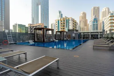 a large swimming pool in a city with tall buildings at Beautiful Stylish Apartment with Marina Views in Dubai