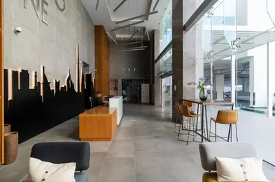 a lobby with chairs and a bar in a building at Beautiful Stylish Apartment with Marina Views in Dubai