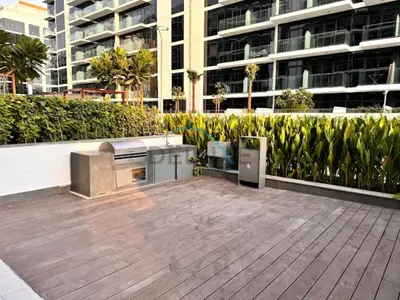 an outdoor patio with a grill and a building at Lovely Studio Apartment at Azizi Riviera 46 in Al Merkadh by Deluxe Holiday Homes in Dubai