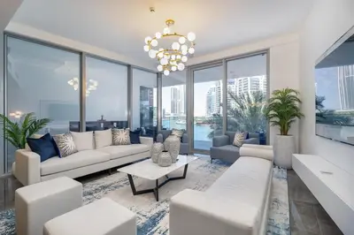a living room with white furniture and large windows at AirDXB - Exceptional 3bedroom with the incredible view in Dubai Marina in Dubai