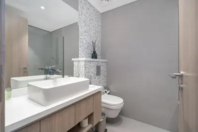 a bathroom with a white sink and a toilet at AirDXB - Exceptional 3bedroom with the incredible view in Dubai Marina in Dubai
