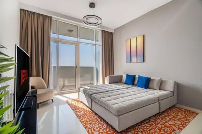 a living room with a couch and a large window at Exquisite 1Bedroom With City Views in Dubai