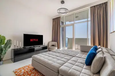 a bedroom with a large bed and a tv at Exquisite 1Bedroom With City Views in Dubai