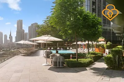 a pool with tables and umbrellas on a building at Keysplease Address Opera 2BR Downtown 26 in Dubai