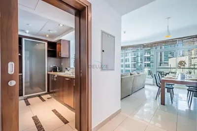 a kitchen and dining room with a dining table at Elegant 2BR in Park Island Bonaire, Dubai Marina by Deluxe Holiday Homes in Dubai