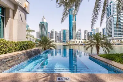 a swimming pool in the middle of a city with skyscrapers at Elegant 2BR in Park Island Bonaire, Dubai Marina by Deluxe Holiday Homes in Dubai