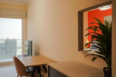 a dining room with a table and a potted plant at Cozy studio in Business Bay Dubai in Dubai