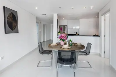 a kitchen and dining room with a table and chairs at The Smart Concierge - Damac Heights in Dubai