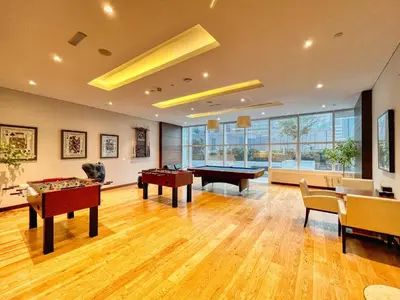 a large room with two tables and pool tables at The Smart Concierge - Damac Heights in Dubai