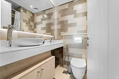 a bathroom with a sink and a toilet at Chic Living 1 BHK with Beach Access in Dubai
