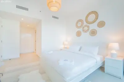 a white bathroom with a white tub in a room at Downtown Views Tower 2 brand new apt in Dubai