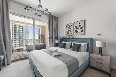 a bedroom with a large bed and a large window at Stylish 1 Br In Unique Location in Dubai