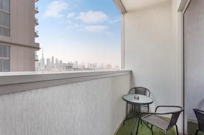 a balcony with a table and chairs and a view of the city at STAY BY LATINEM Luxury 2BR Holiday Home CV A813 near Burj Khalifa in Dubai