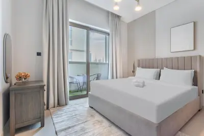 a bedroom with a large white bed and a window at STAY BY LATINEM Luxury 2BR Holiday Home CV A813 near Burj Khalifa in Dubai