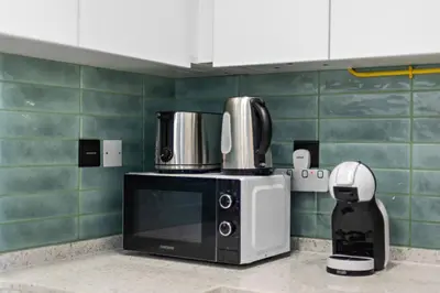 a microwave sitting on top of a kitchen counter at Unique 1 BHK Near To Metro in Dubai