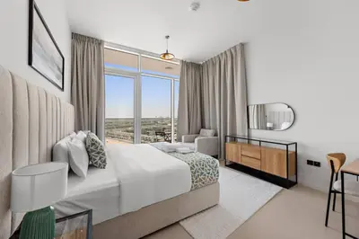 a bedroom with a bed and a large window at Unique 1 BHK Near To Metro in Dubai