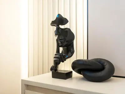 a black statue of a person with a lamp on a table at Burj Khalifa & Fountain Show Views 4 BHK In Downtown, 2 minutes walk to Dubai Mall in Dubai