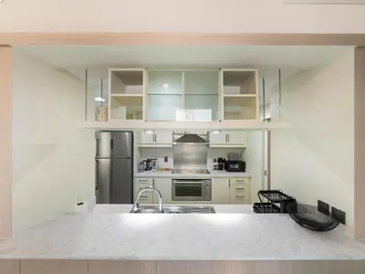a kitchen with a sink and a refrigerator at Burj Khalifa & Fountain Show Views 4 BHK In Downtown, 2 minutes walk to Dubai Mall in Dubai