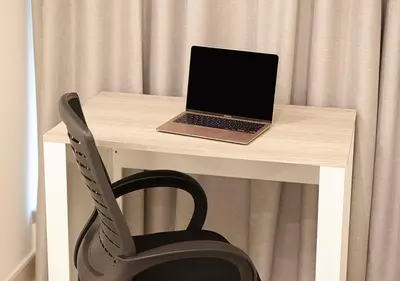 a laptop computer sitting on a desk with a chair at Coastal Marina Escape - 4 BR Sea, Dubai Eye & Palm View in Dubai