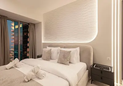 a white bedroom with two beds and a window at Coastal Marina Escape - 4 BR Sea, Dubai Eye & Palm View in Dubai