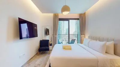 a hotel room with a large bed and a balcony at Locations I Ahad Residences I Luxurious Studio Apartment I Business Bay I 10-Min Drive to Downtown Dubai & Burj Khalifa in Dubai