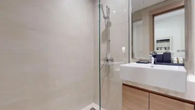 a bathroom with a sink and a shower at Azizi Riviera 9 - Bright Studio in Meydan in Dubai