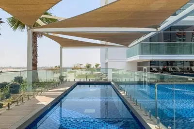 a swimming pool on the roof of a building at Cozy and Stylish Studio Retreat in DAMAC Hills in Dubai