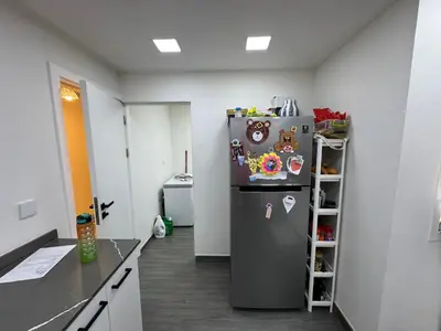 a kitchen with a refrigerator with magnets on it at Lovely Brand new 3 BR with maids room in Dubai
