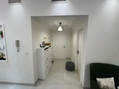 a room with a hallway with a dresser at Lovely Brand new 3 BR with maids room in Dubai