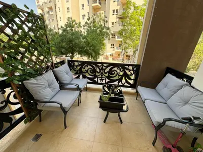 a balcony with couches and a table on a balcony at Lovely Brand new 3 BR with maids room in Dubai