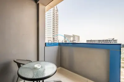 a table and chair in a room with a window at Lovely 2BR at The Signature, Downtown Dubai by Deluxe Holiday Homes in Dubai