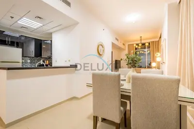 a dining room and kitchen with a table and chairs at Stunning 1BR Apartment at Botanica Tower 1, Dubai Marina by Deluxe Holiday Homes in Dubai