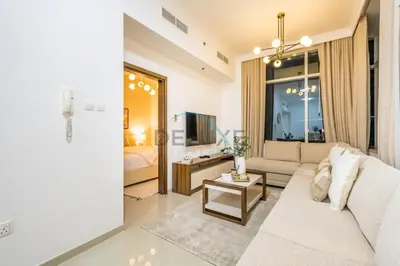 a living room with a couch and a television at Stunning 1BR Apartment at Botanica Tower 1, Dubai Marina by Deluxe Holiday Homes in Dubai