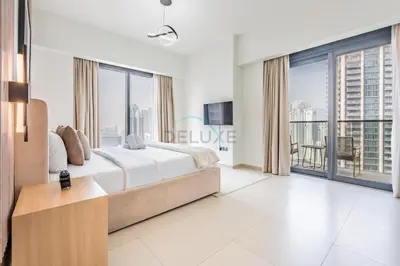 a bedroom with a large bed and large windows at Magnificent 2BR Apartment at Act One Act Two Tower 2 in Downtown Dubai by Deluxe Holiday Homes in Dubai