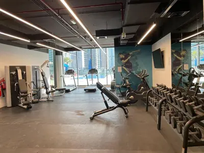 a gym with cardio equipment and chairs in a room at Dubai Marina, LIV Residence, Luxury Studio Apartment in Dubai