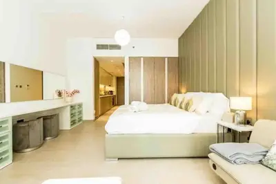 a large white bedroom with a bed and a couch at Dubai Marina, LIV Residence, Luxury Studio Apartment in Dubai