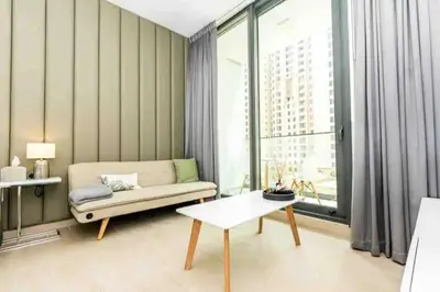 a living room with a couch and a table at Dubai Marina, LIV Residence, Luxury Studio Apartment in Dubai