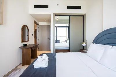 a hotel room with a bed and a bathroom at Binghatti Emerald, JVC- Charming 1-BR Apartment in Dubai