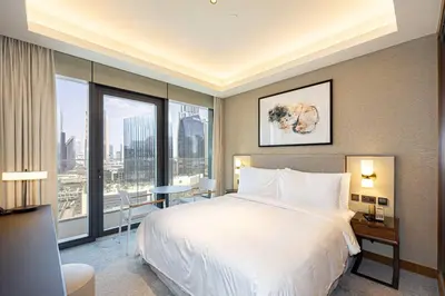 a bedroom with a large bed and a large window at Stunning Address Opera 3Bedroom in Dubai