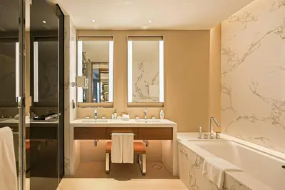 a bathroom with a tub and two sinks and a bath tub at Stunning Address Opera 3Bedroom in Dubai
