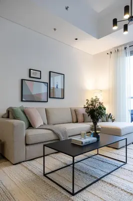 a living room with a couch and a coffee table at 2BR API 1000 Community View Jumeirah in Dubai