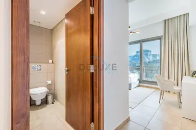 a bathroom with a toilet and a sink at Chic 2BR Apartment with Pool View in Marina Apartment 6, Palm Jumeirah by Deluxe Holiday Homes in Dubai