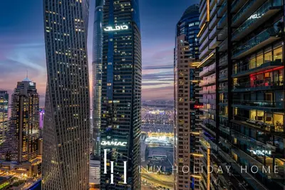 a city skyline at night with tall buildings at LUX The Marina Gate Sea View Suite in Dubai
