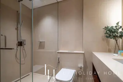 a shower stall with a toilet in a bathroom at LUX The Marina Gate Sea View Suite in Dubai