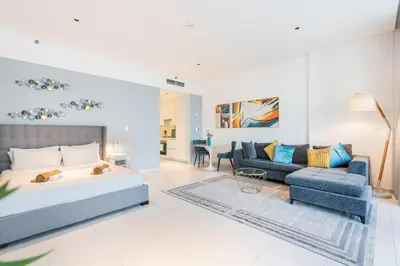 a bedroom with a bed and a living room at Stunning Home Overlooking the Burj Khalifa in Dubai