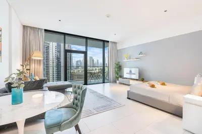 a bedroom with a bed and a table and a couch at Stunning Home Overlooking the Burj Khalifa in Dubai
