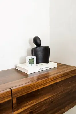 a black chair sitting on top of a table at New Cozy 1BR in the Heart of the City in Dubai
